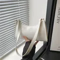 Minimalist white patent leather baguette bag for women with golden metal hardware - Glossy White