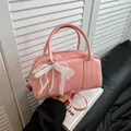 Pink Boston bag with white lace bow and pearl charms in a handheld display - Pink (With Pendant)