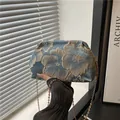 Light blue cloud pouch with gold floral embroidery and slim metal chain strap - Blue