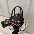 Black pumpkin shoulder bag with pink spider web embroidery and scary face design - Black & Pink