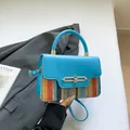 Blue leather crossbody bag with colorful woven base and gold metal buckle hardware - Blue
