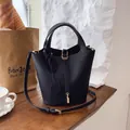 Chic black litchi pattern bucket bag with golden padlock pendant and leather top handle - Black