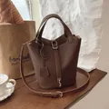 Dark brown lychee grain leather bucket bag with double handles and a metal lock - Brown