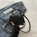 Minimalist black PU leather crossbody bag with top handle and gold hardware detail - Black