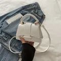 Elegant white minimalist crossbody bag with gold ring buckle and leather handle - White