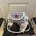 Blue and white checkered mini saddle bag with red apple embroidery and knotted strap - White