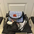 Blue plaid mini saddle bag with red apple embroidery and black crossbody strap - Black