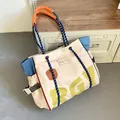 Detail of canvas tote bag with RGY print, blue denim side panel and woven orange handle - Off White