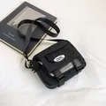 Fashionable black nylon crossbody bag with multi-pocket design and adjustable strap - Black