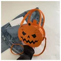 Detail of Jack-o'-lantern pumpkin bag with spider web stitching and adjustable strap - Orange Red