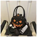 Detailed macro view of black PU leather pumpkin bag with orange spider web embroidery - Black Orange