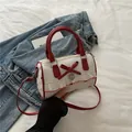 White Boston underarm bag with red bow print and heart charm for casual wear - Red