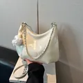 Creamy white hobo bag in glossy patent leather with silver chain strap and plush charm - White