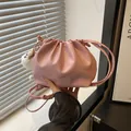 Pink pleated dumpling bag in smooth PU leather with drawstring and plush pompom charm - With Pendant / Pink