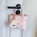 Pink cartoon print bucket bag with butterfly motifs and plush white charm on a door - With Charm / Pink