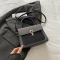 Minimalist small square bag in black and grey textured拼接 with golden horseshoe buckle - Black
