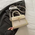Cream white crossbody bag with gold horseshoe buckle and woven texture detailing - Off White