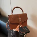 Chic dark brown faux leather crossbody bag with snake skin embossing and gold buckle - Brown