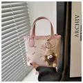 Pale pink mini tote bucket bag with cartoon graphics and a cute monster plush charm - With Pendant / Pink
