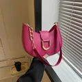 Chic magenta half-moon shoulder bag with bold gold U-shaped buckle and chain strap - Rose Red