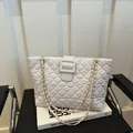 White quilted shoulder bag with gold chain strap and elegant faux leather texture - White