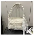 Close-up of beige lace underarm bag with multi-layer floral ruffles and a large bow charm - White With Pendant