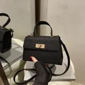 Sparkly black glitter handbag with gold metallic twist lock and versatile strap - Black
