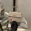Sparkling champagne gold rhinestone handbag with metallic turn-lock and crossbody strap - Gold