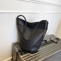 Minimalist black leather bucket bag with silver chain on metallic luggage - Black