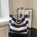 Minimalist canvas tote bag with classic blue and white stripes and sturdy shoulder straps - Blue