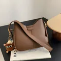 Minimalist brown crossbody bag with wide strap and cute plush charm on a book - With Pendant / Brown