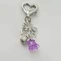 Close-up of heart-shaped clasp and bow pendant with purple resin bell flower charm - Rose Bow / Purple