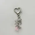 Detail of silver bow and heart clasp keychain with pink rose petal charms on white base - Rose Bow / Pink