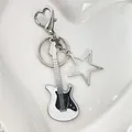 Y2K electric guitar keychain with heart carabiner and star charm in silver and black - White