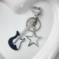 Y2K punk style guitar and pentagram metal keychain with heart-shaped clip on a tray - Black