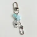 Cute fish beaded phone charm with blue stars and silver heart pin on gray background - Keychain Hook Style