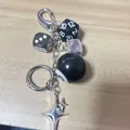 Detail of retro dice keychain with stars and dark green mixed beads hanging on wood - Black Polyhedral Dice Style / Black Dice Star Pendant Combination (5959330435416)
