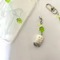 Cute plush sea otter phone charm with green clover beads and a matching white case - White Woven Rope Style