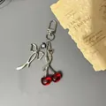 Sweet cherry charm with silver bow and star pendant on a stylish metal phone chain - Metal Buckle Style