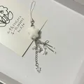 Star plush phone charm with beads and metal bow on a decorative display card - Phone Lanyard