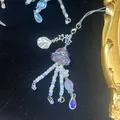 Perlen-Handykette mit lila Qualle, silbernen Sternen und Muscheln auf Samt - Handykette / Lila