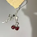 Y2K cherry bow phone strap with silver star and heart pendant on gray background - Phone Lanyard Style
