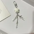 White fuzzy star keychain with silver bow, pearls and colorful star pendant charms - Keychain