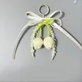 Detalle del colgante de tulipán tejido con lazo de seda y perlas para bolsos y llaves - Estilo Tulipán Blanco Crema