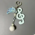 Detail of clef keychain with blue stripes, translucent wings and soft white plush ball - Blue White Striped G-Clef Style