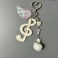 G-clef music keychain with white polka dots, iridescent wing, and fluffy pom-pom charm - White Red Dot G-Clef Style