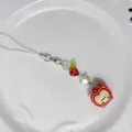 Handmade beaded phone strap featuring a cute red apple pendant with cartoon smile - Apple