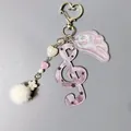 Porte-clés clé de sol violet avec ailes roses scintillantes et pompon blanc en peluche - Note de Musique Etoile Violette