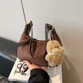 Deep brown matte suede crescent shoulder bag with a cute plush dog pendant charm - Coffee With Pendant