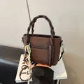 Dark brown leather handbag with woven rope handle and fashion embossed lettering - Brown